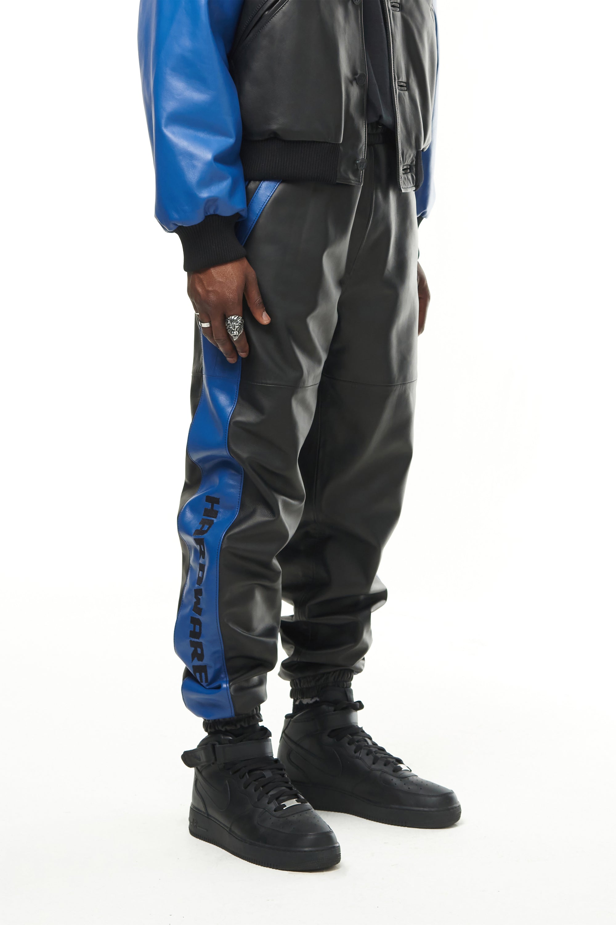 THE VIRALIZER UNISEX LEATHER TRACKSUIT BOTTOMS IN BLACK AND ROYAL BLUE